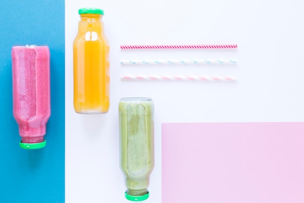 Flat lay bottles with smoothie on table