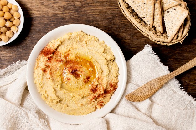 Flat lay of bowl of hummus with chickpeas