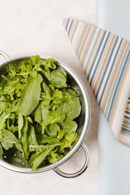 Flat lay of bowl of salad on cloth