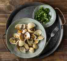 Free photo flat lay bowl with shells arrangement