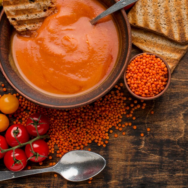 Flat lay of bowl with winter squash soup and toast