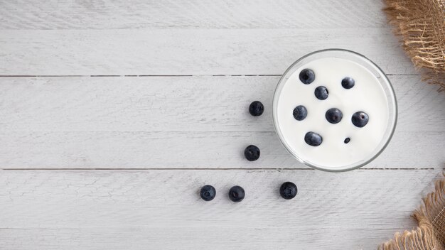 Flat lay bowl with yogurt and blueberries