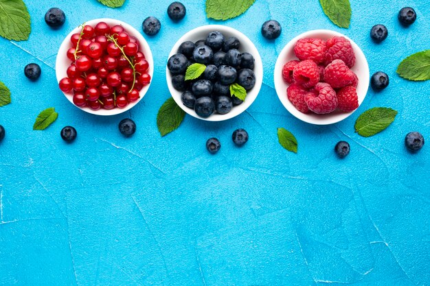 Flat-lay of bowls of berries with copy space