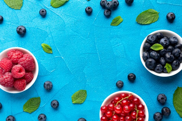 Flat-lay of bowls of berries with copy space