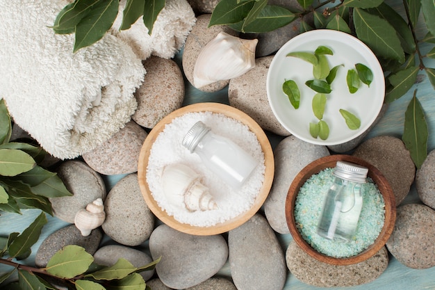 Flat lay bowls with salt on spa stones