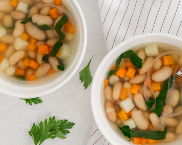 Flat lay bowls with white beans soup