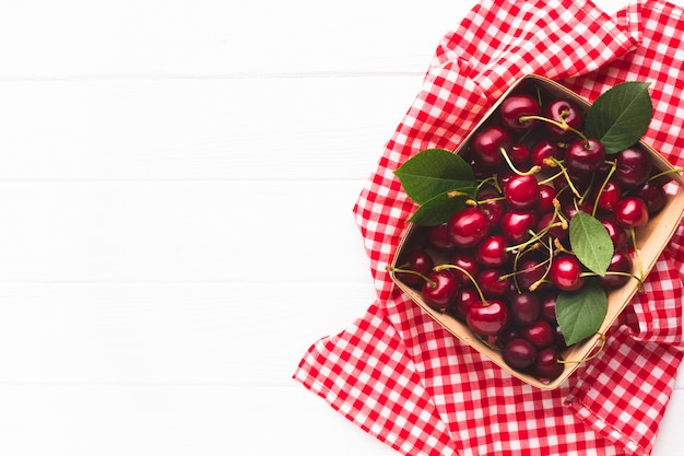 Flat-lay box of berries on tablecloth