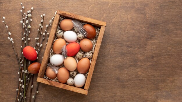 Flat lay of box with eggs for easter and copy space