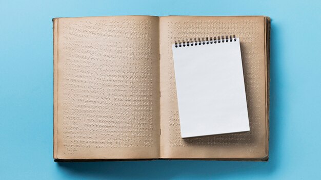 Flat lay braille book on blue background