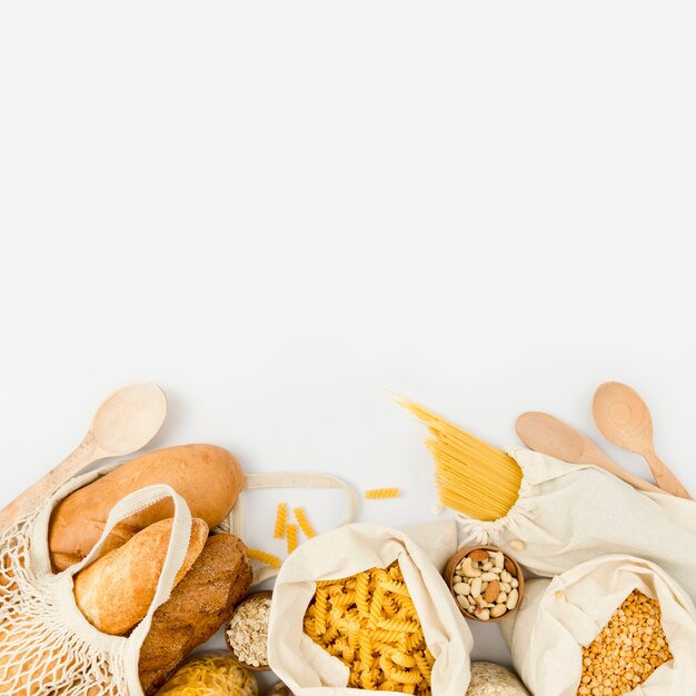 Flat lay of bread in reusable bag with bulk pasta