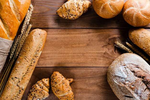 Flat lay of bread on wooden table with copy space