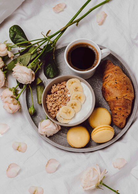 Flat lay of breakfast bowl with cereal and macarons