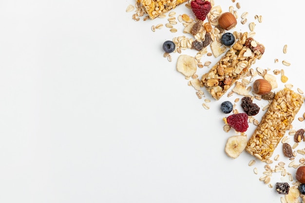 Flat lay of breakfast cereal bars with fruits