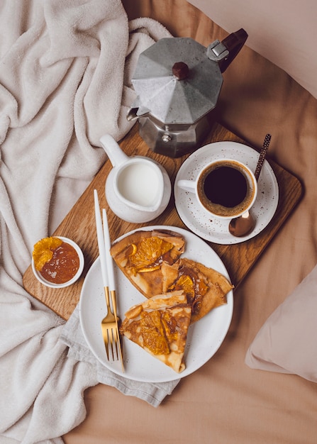 Flat lay of breakfast crepes with jam