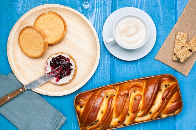 Flat lay brioche with butter jam and orange juice