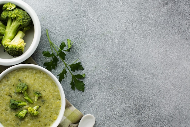 Flat lay broccoli bisque in bowl with copy space