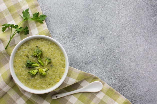 Flat lay broccoli bisque on kitchen towel with copy space
