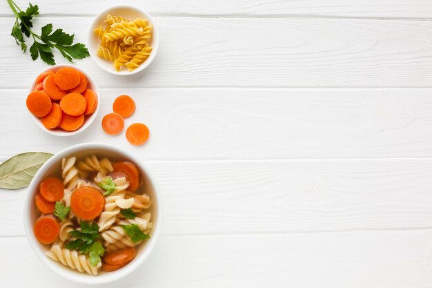 Flat lay broccoli carrots and fusilli in bowl with copy space