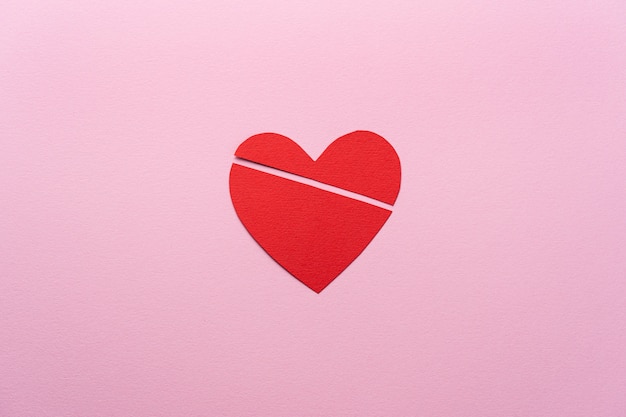 Flat lay broken heart on pink background