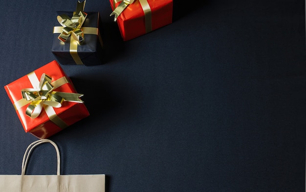 Flat lay of a brown eco paper bag and Christmas gift boxes with copy space