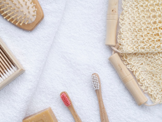 Flat lay brushes and soap on white towels