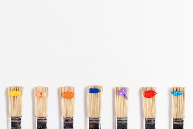 Flat lay of brushes with paint drops
