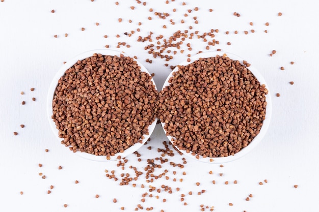 Flat lay buckwheats in bowls . horizontal