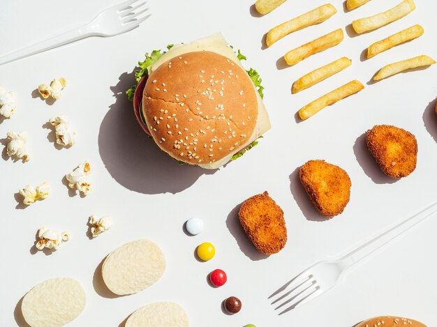 Flat lay of burger, fries, nuggets and chips