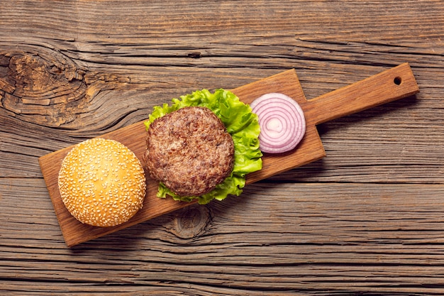 Flat lay burger ingredients on a cutting board