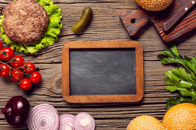 Free photo flat lay burger ingredients with chalkboard