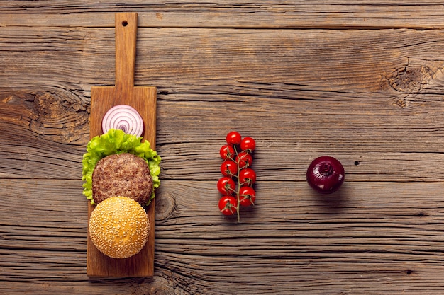 Flat lay burger ingredients on a wooden table