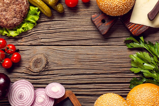 Flat lay burger ingredients on wooden table