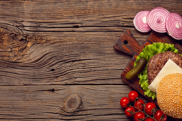 Flat lay burger ingredients on wooden table