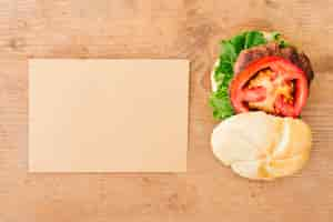 Free photo flat-lay burger on slate with cardboard