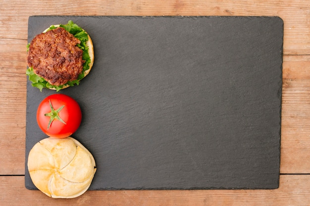 Flat-lay burger on slate with copyspace