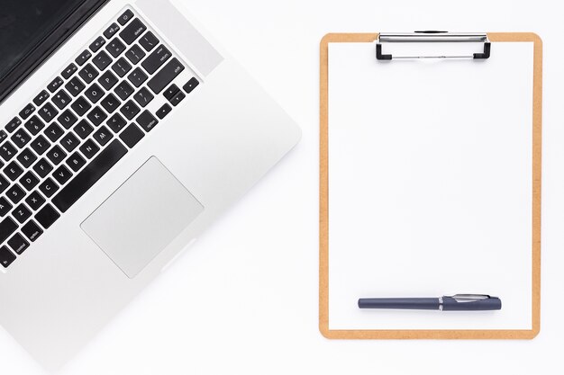 Flat lay business desk composition with empty clipboard