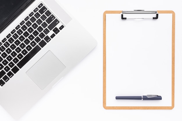 Flat lay business desk composition with empty clipboard