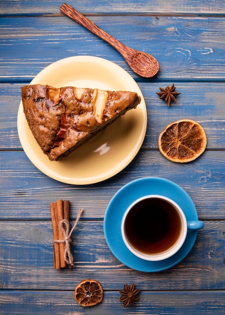 Flat lay of cake slice with cup of tea