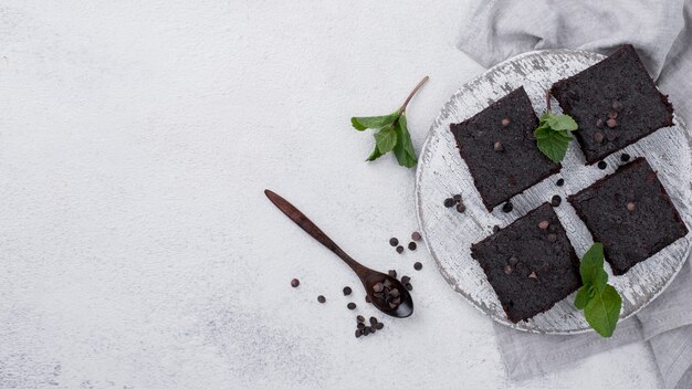 Flat lay of cake with mint and spoon