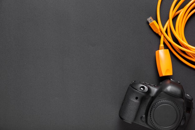 Flat lay of camera on black background with copy-space