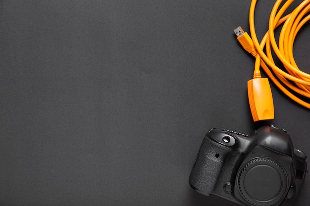 Flat lay of camera on black background with copy-space