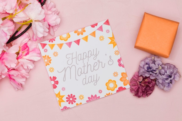 Flat lay of card and flowers for mothers day with present