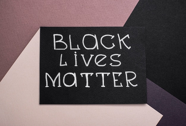 Flat lay of card with black lives matter slogan