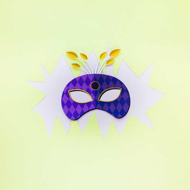 Flat lay of carnival mask on paper cut-out