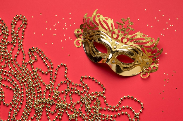 Flat lay of carnival mask with beads