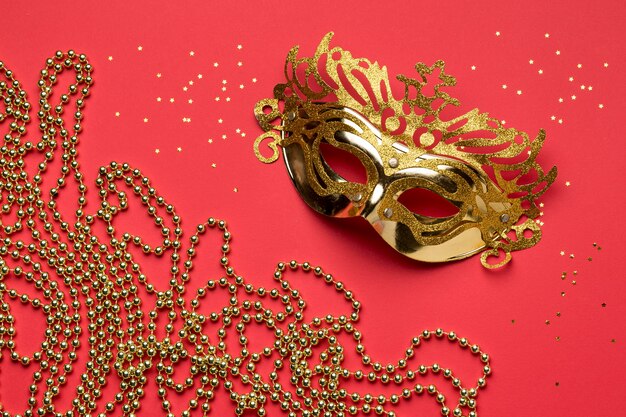 Flat lay of carnival mask with beads