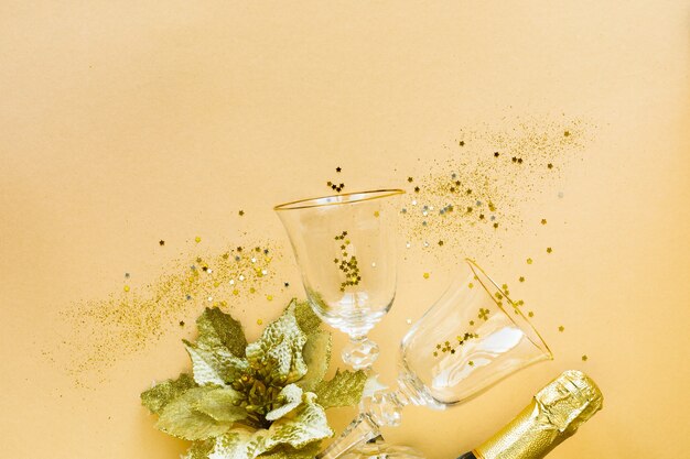 Flat lay of celebration. Two glasses for champagne and gifts on a yellow background