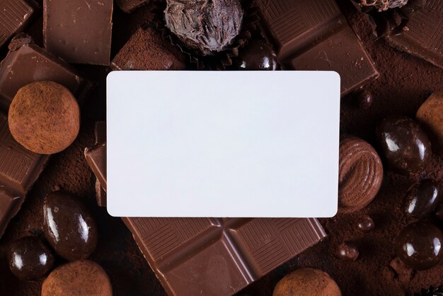 Flat lay chocolate bars and candies with rectangle mock-up