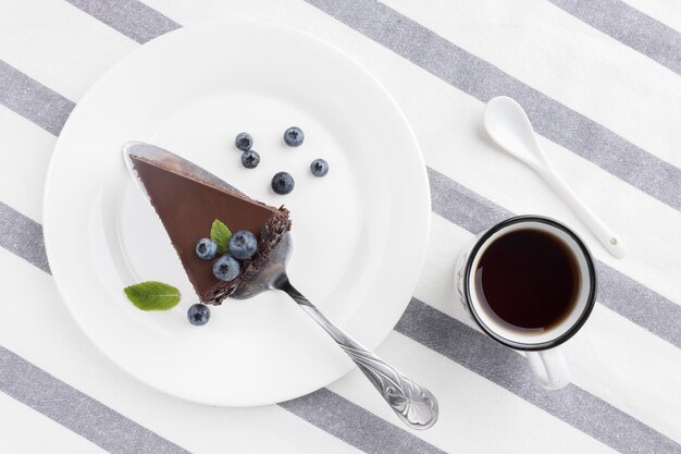 Flat lay of chocolate cake slice on plate
