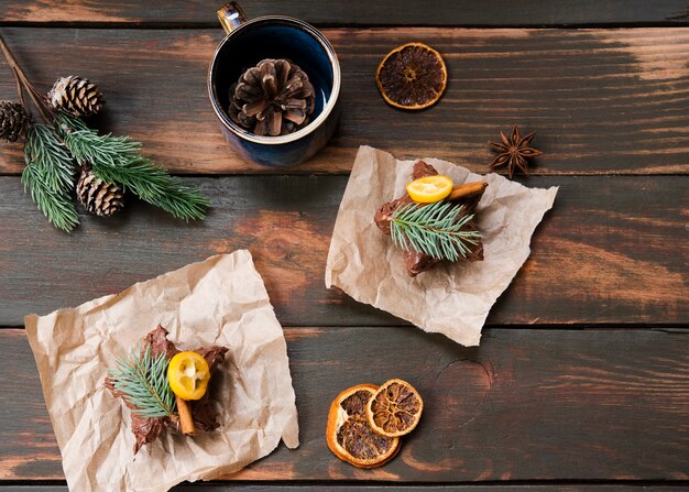 Flat lay of chocolate covered pastry with dried citrus